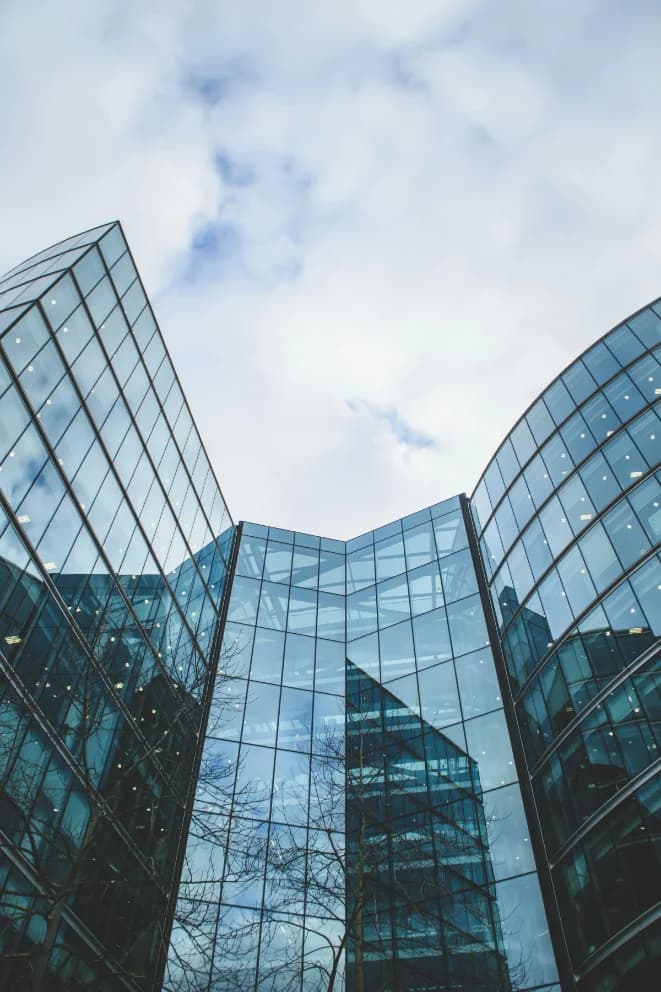 A glass office tower seen from below